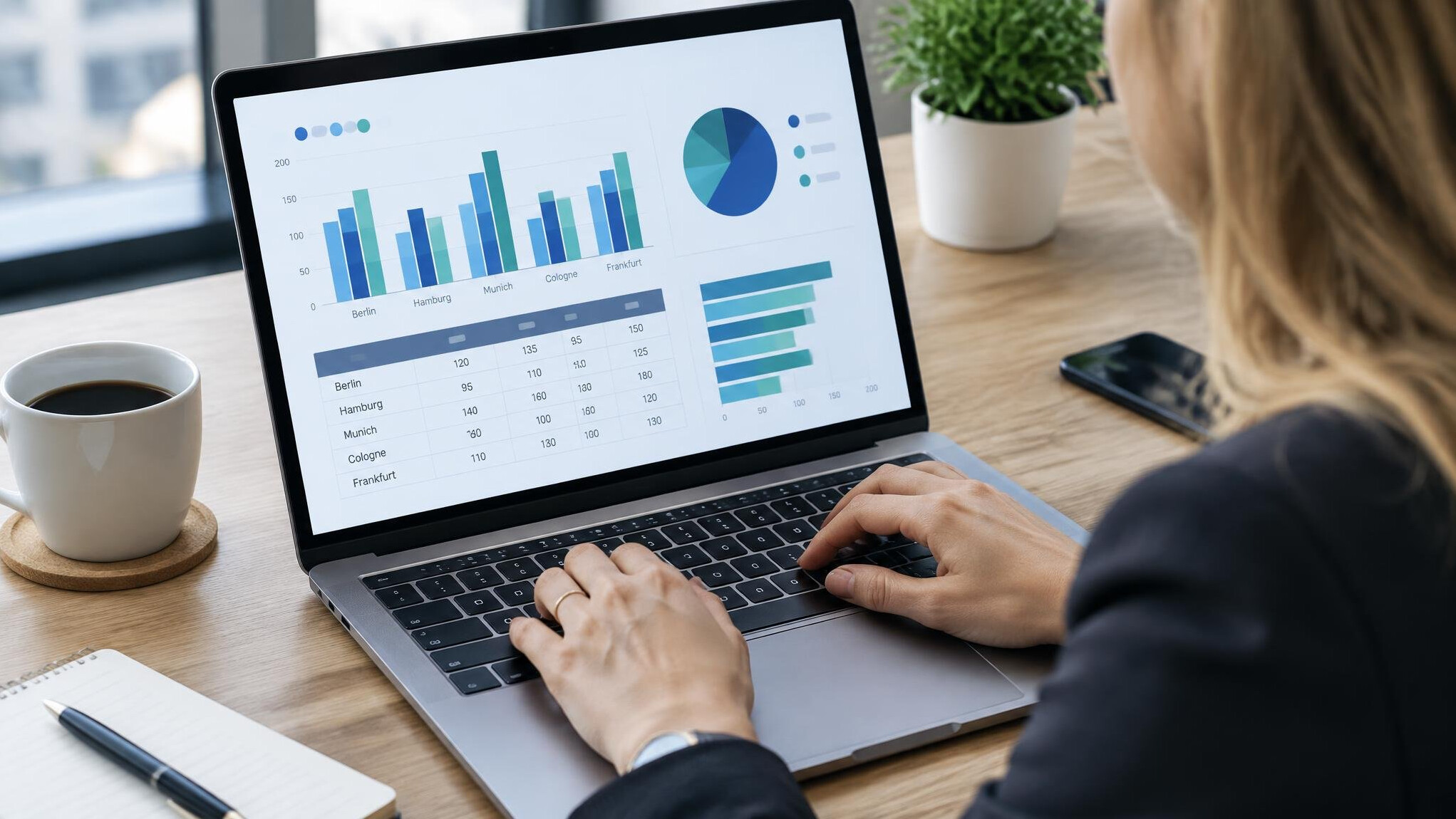 Analyst preparing a market demand report on a laptop
